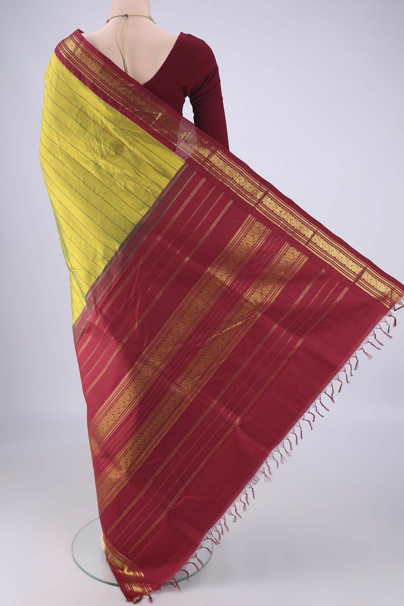 Flat view of Green Kanchipuram Silk Saree with Stripes on the body and Zari Border. 