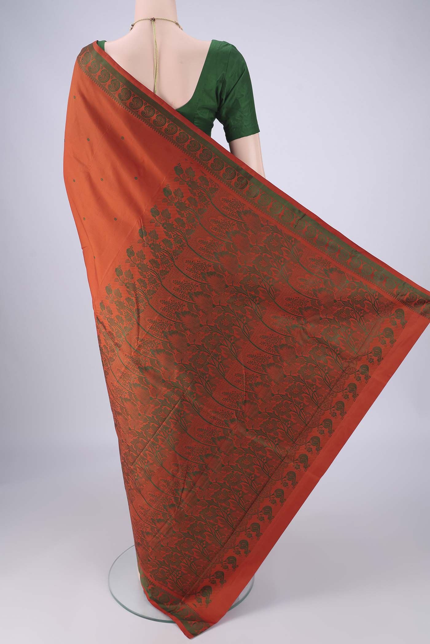 Flat view of Rust Kanchipuram Silk Saree with Thread Butta on the body and Thread Border. 
