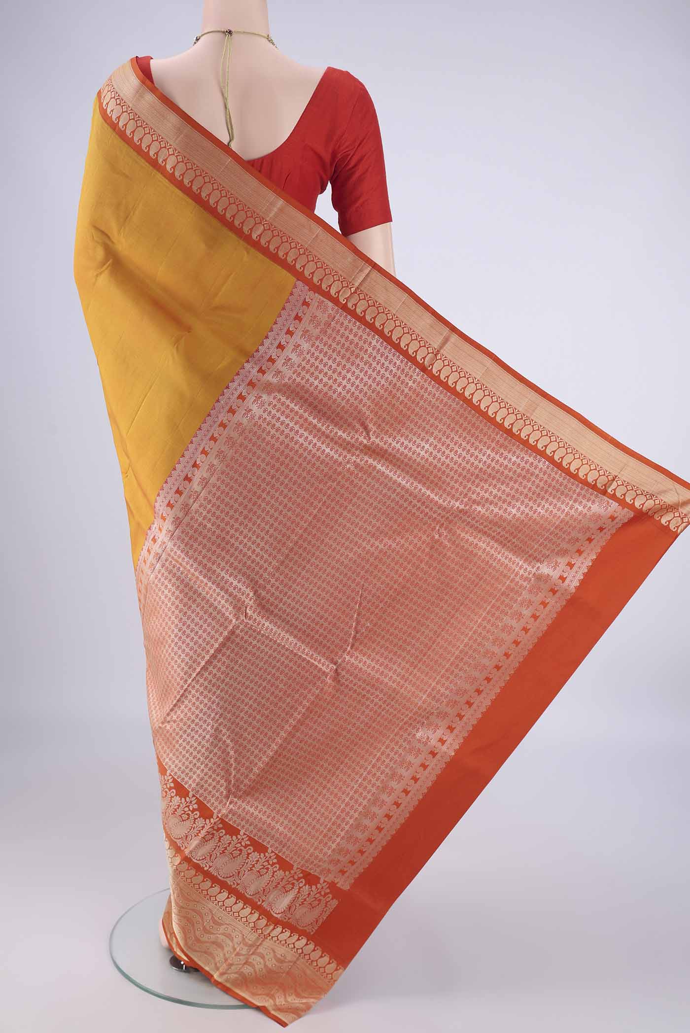 Flat view of Mustard Kanjivaram Silk Saree with Plain Body and Thread Border. 
