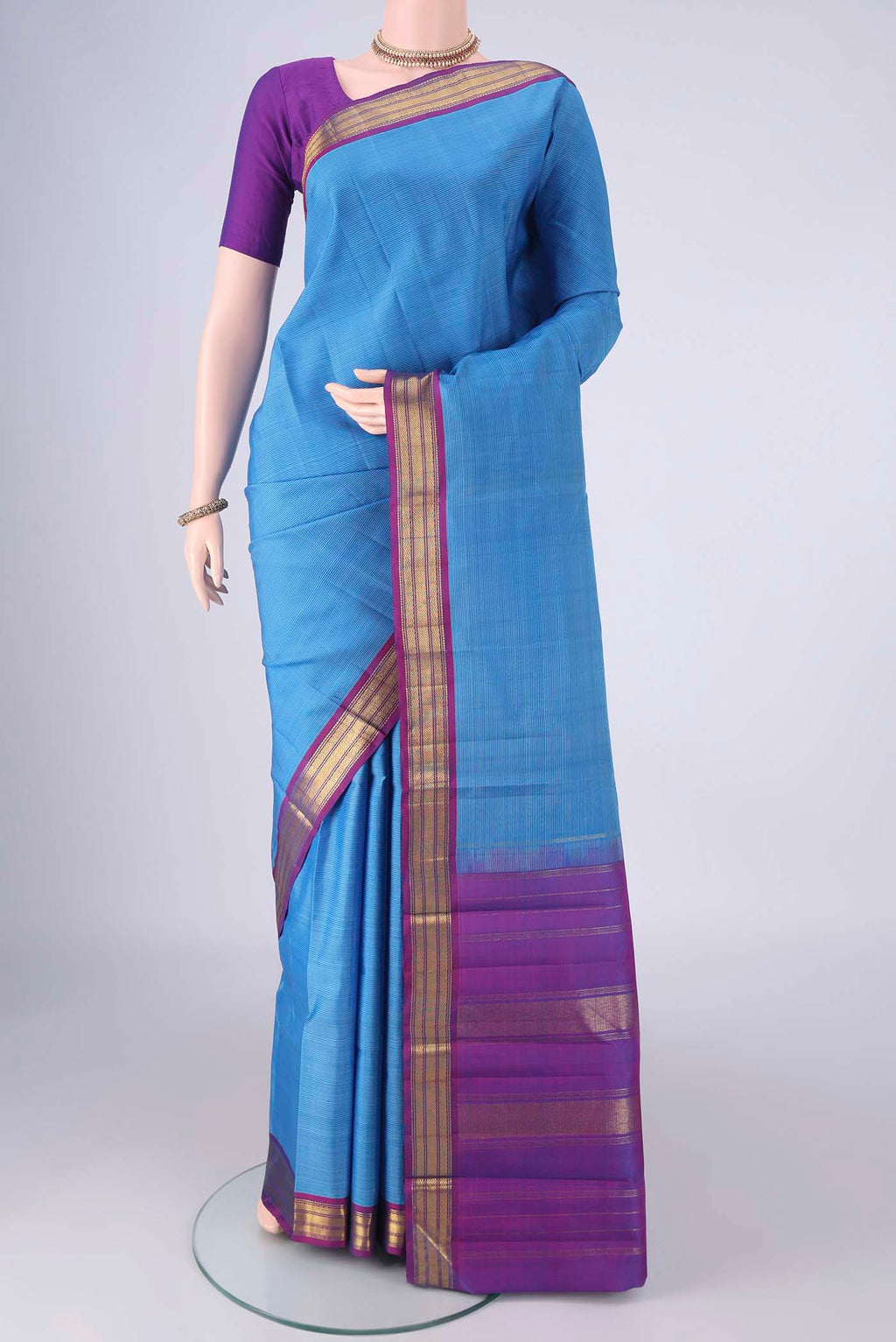Blue Kanjivaram Silk Saree with Stripes on the body and Zari Border.  displayed on a mannequin