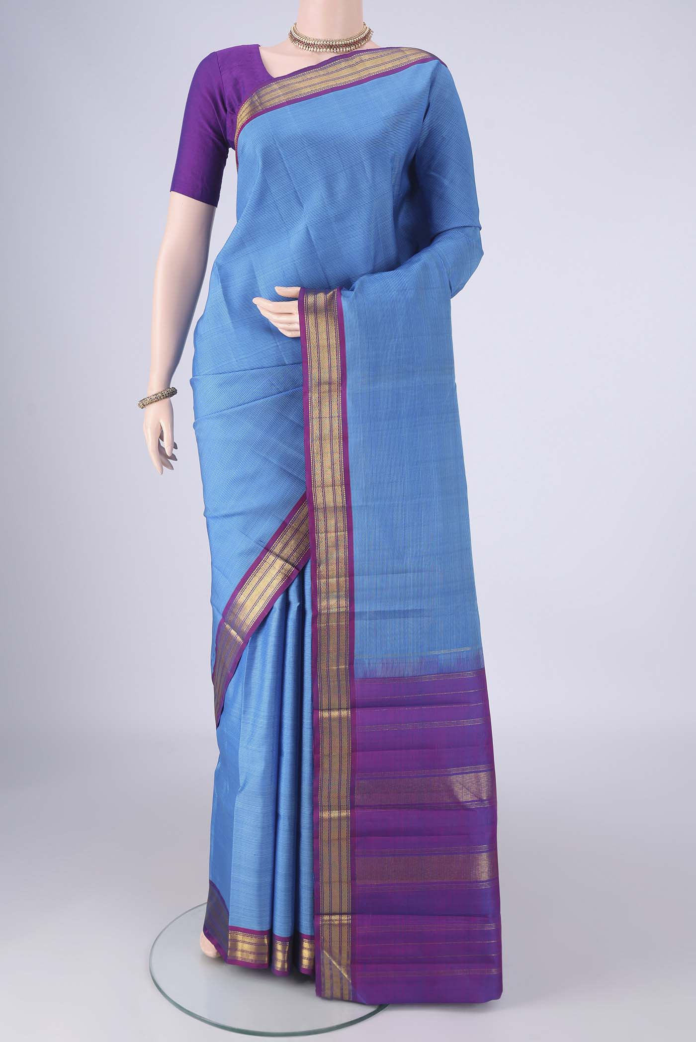 Blue Kanjivaram Silk Saree with Stripes on the body and Zari Border.  displayed on a mannequin