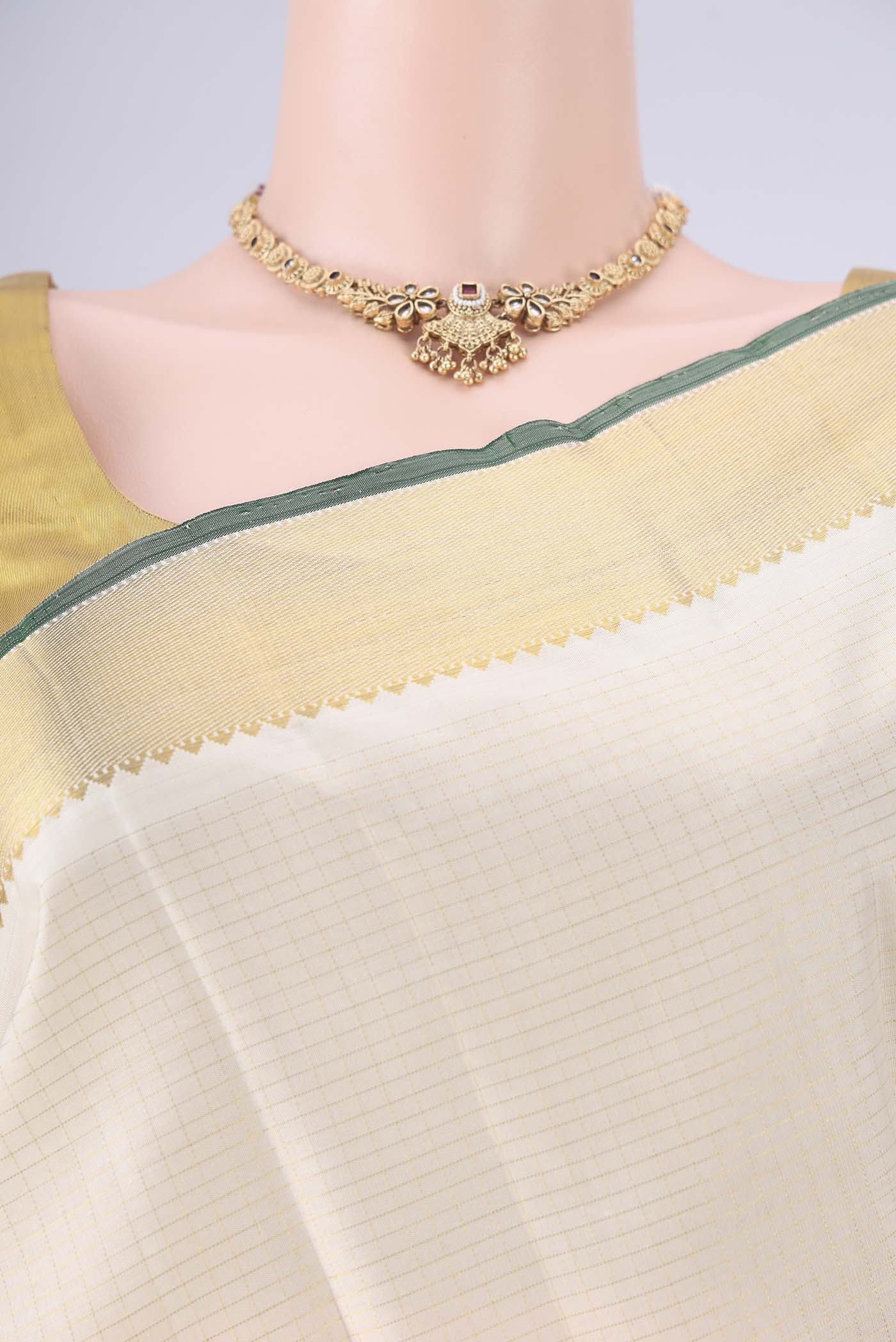 Border image of Off White Kanchipuram Silk Saree with Checked design on the body and Zari Border. 