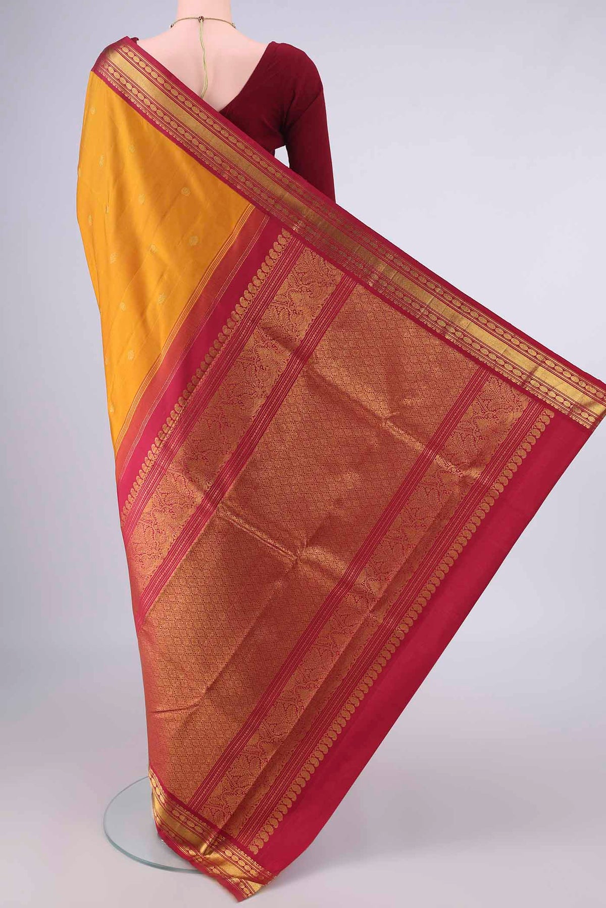 Flat view of Pure Silk Mustard Kanchipuram Saree with Zari Butta on the body and Zari Border. 