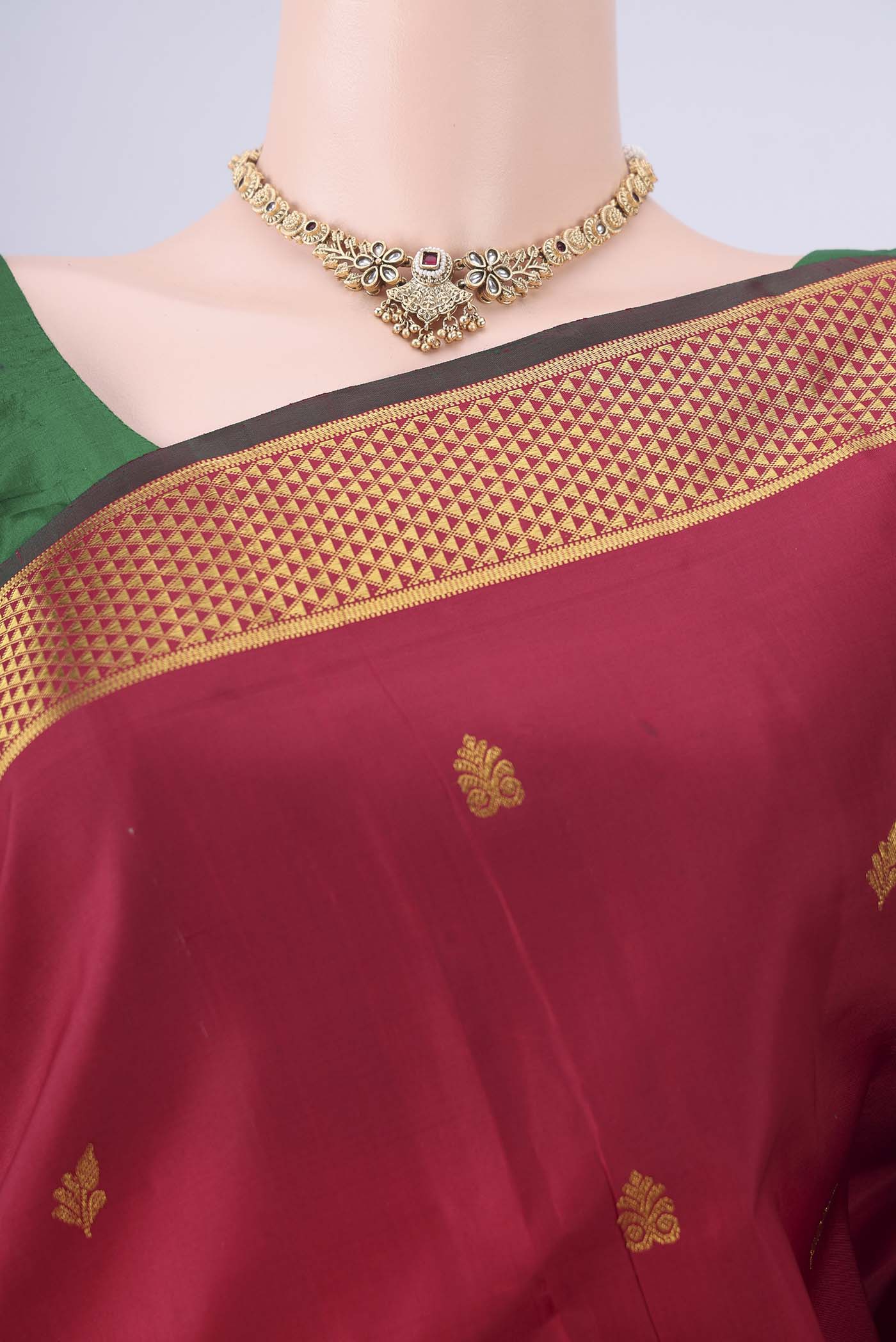 Border image of Maroon Kanchipuram Silk Saree with Zari Butta on the body and Zari Border. 