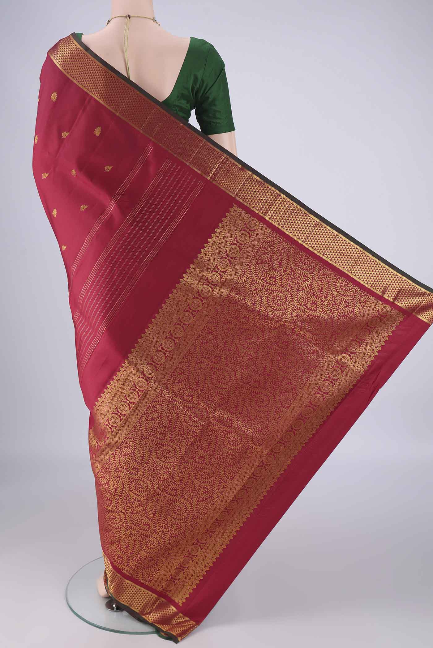 Flat view of Maroon Kanchipuram Silk Saree with Zari Butta on the body and Zari Border. 