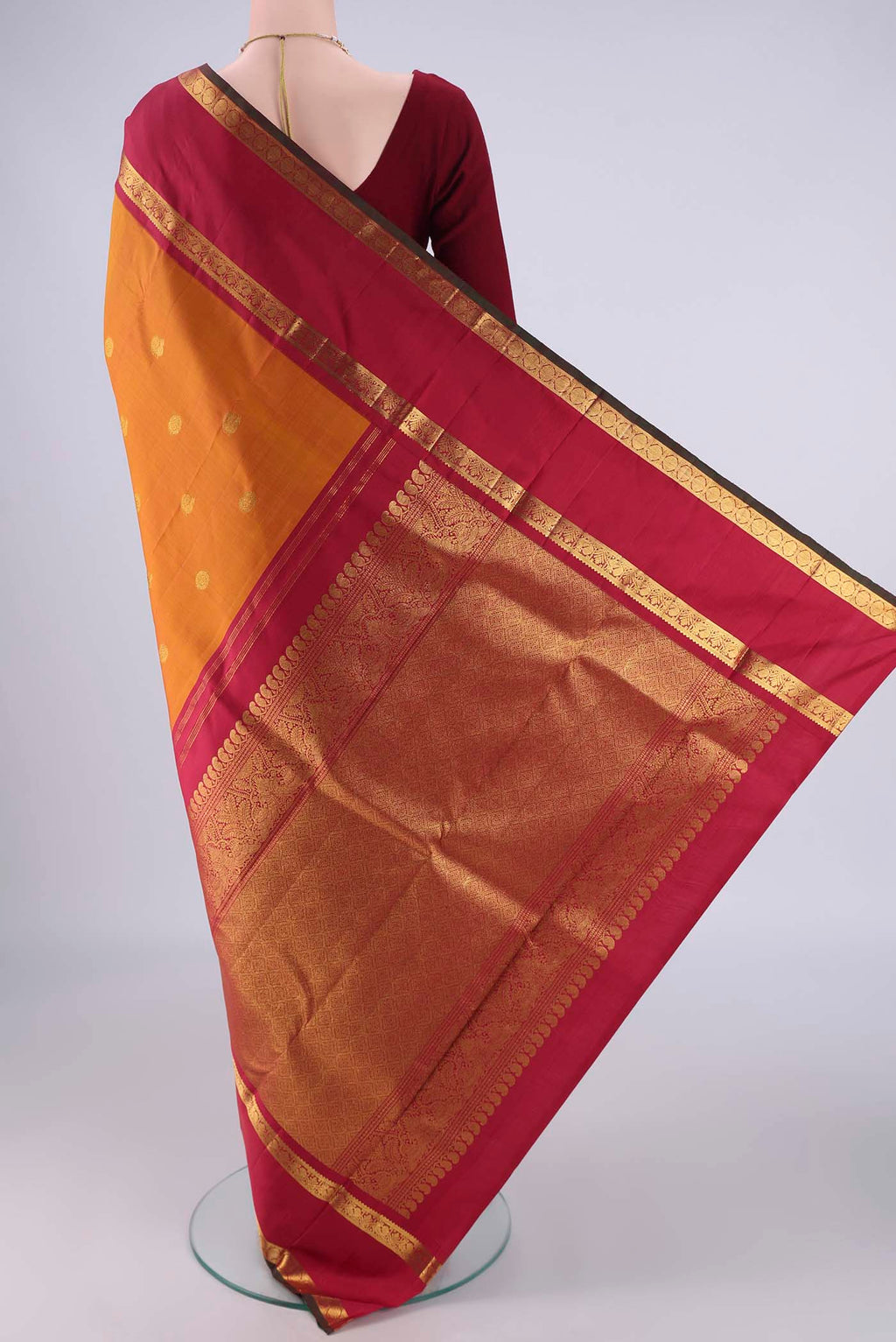 Flat view of Mustard Kanchipuram Silk Saree with Zari Butta on the body and Zari Border. 
