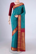 Blue Kanchipuram Silk Saree with Zari Butta on the body and Zari Border.  displayed on a mannequin