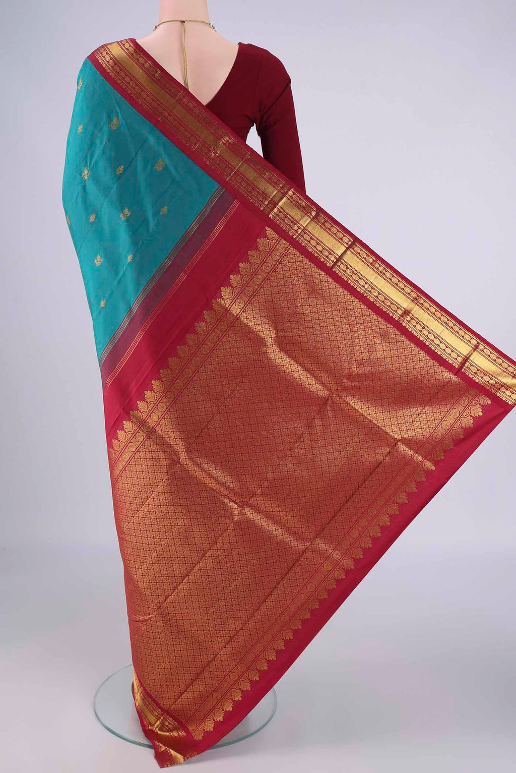 Flat view of Blue Kanchipuram Silk Saree with Zari Butta on the body and Zari Border. 
