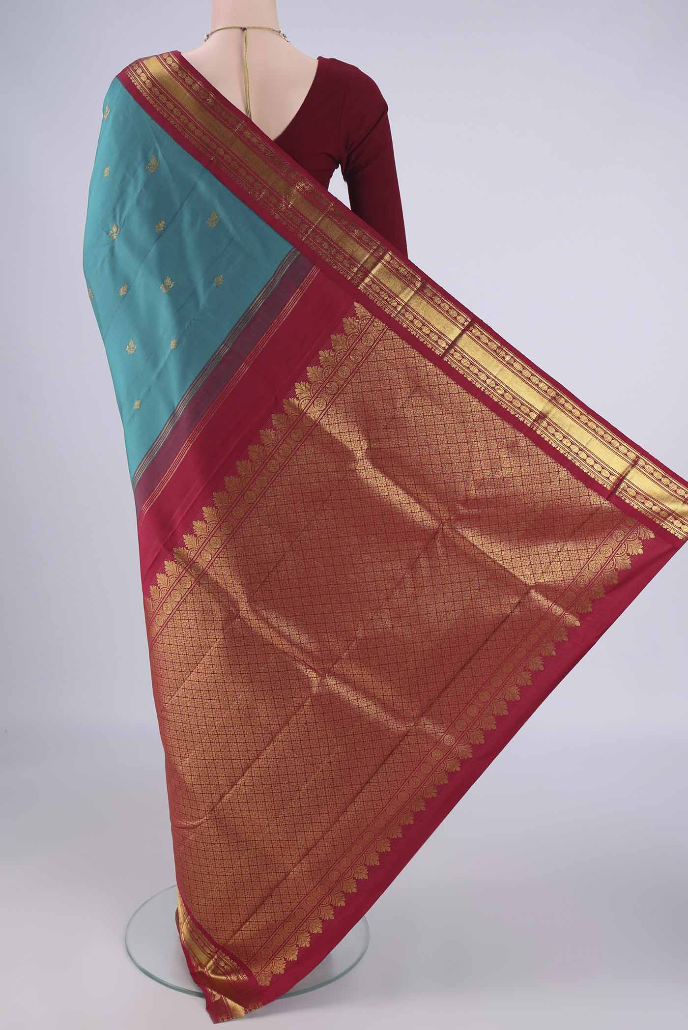 Flat view of Blue Kanchipuram Silk Saree with Zari Butta on the body and Zari Border. 