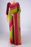 Green Kanchipuram Silk Saree with Zari Butta on the body and Zari Border.  displayed on a mannequin