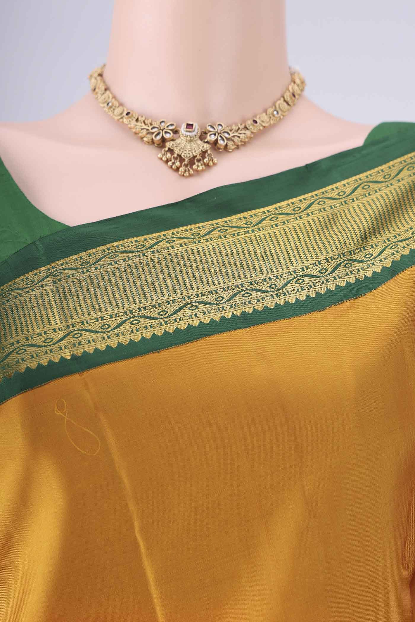 Border image of Yellow Kanchipuram Silk Saree with Zari Butta on the body and Zari Border. 