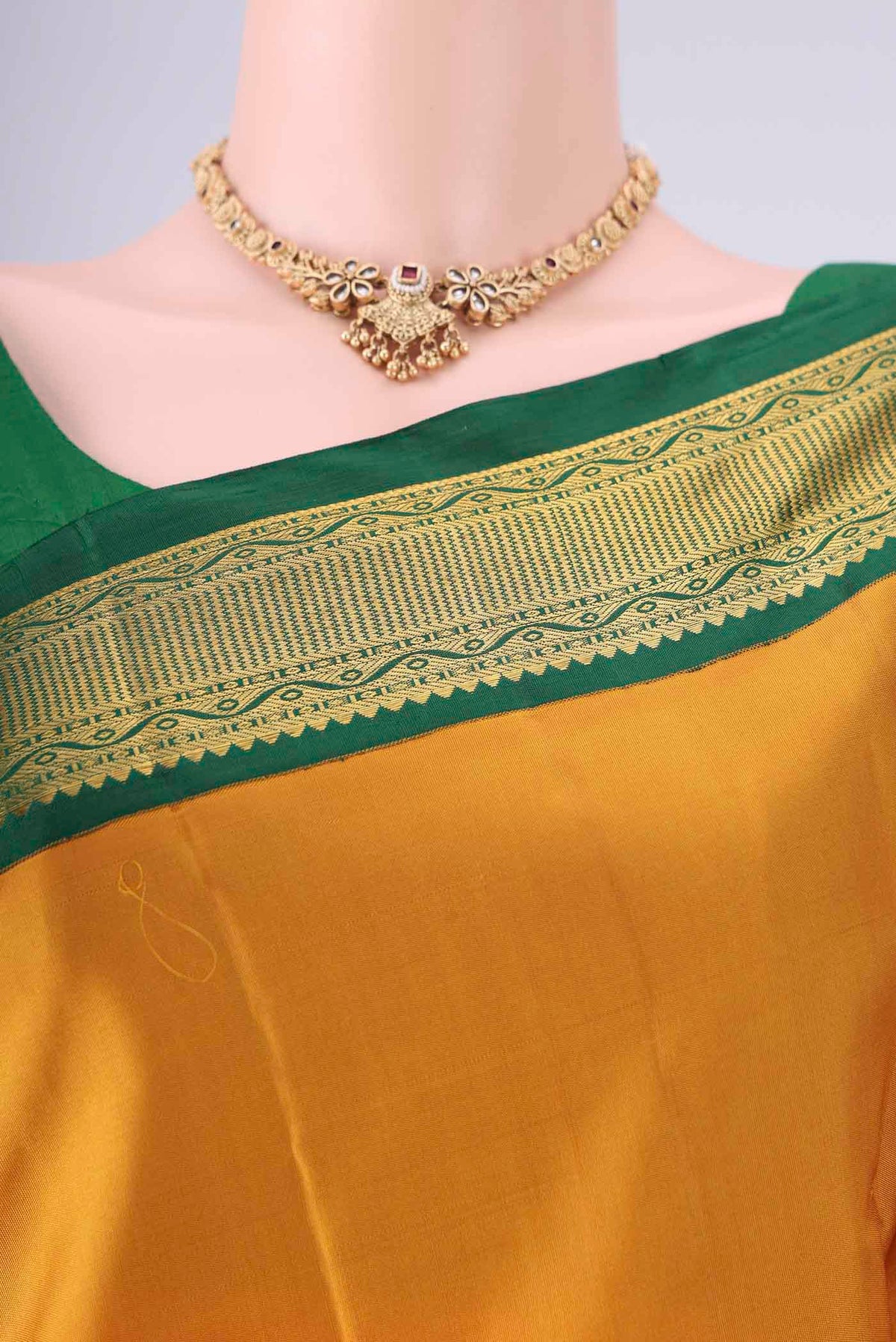 Border image of Yellow Kanchipuram Silk Saree with Zari Butta on the body and Zari Border. 