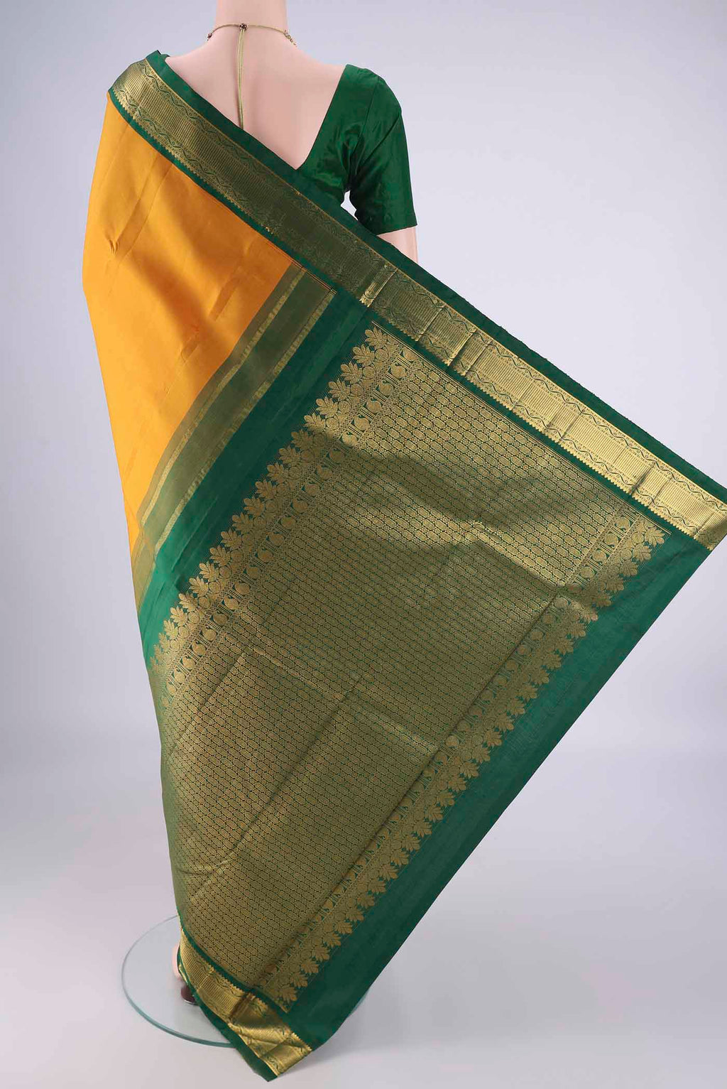 Flat view of Yellow Kanchipuram Silk Saree with Zari Butta on the body and Zari Border. 