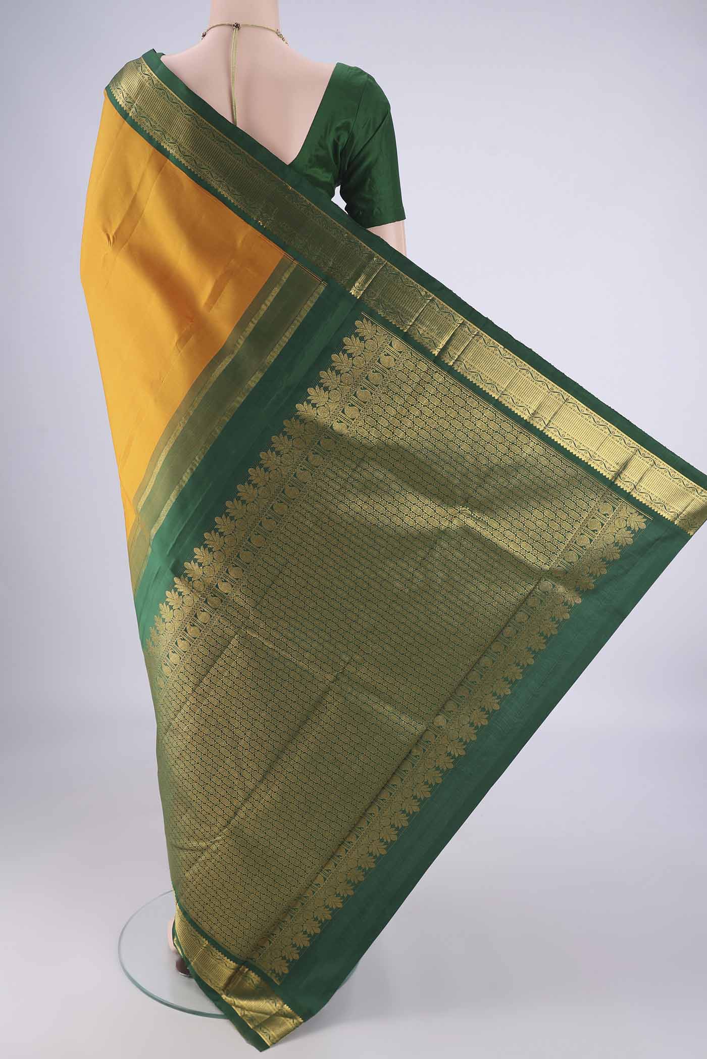 Flat view of Yellow Kanchipuram Silk Saree with Zari Butta on the body and Zari Border. 