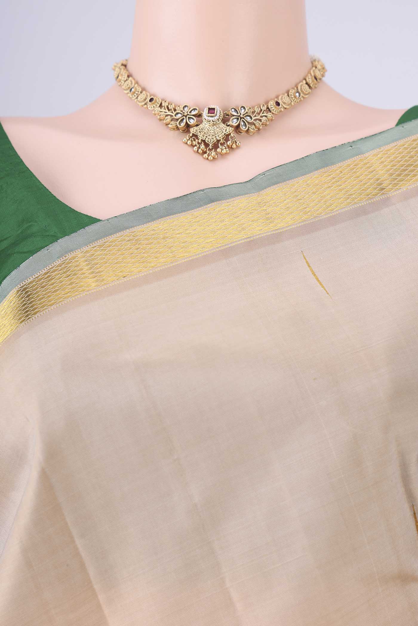 Border image of Cream Kanjivaram Silk Saree with Zari Butta on the body and Zari Border. 