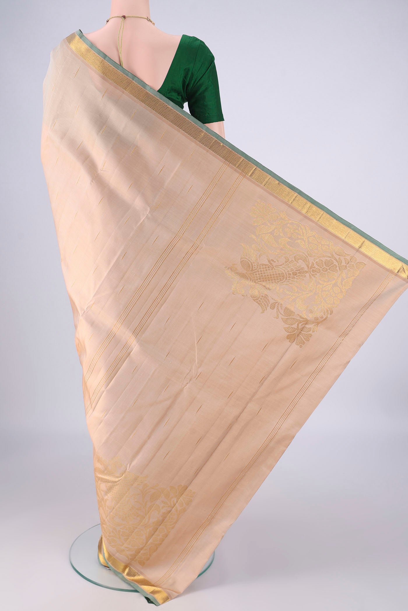 Flat view of Cream Kanjivaram Silk Saree with Zari Butta on the body and Zari Border. 