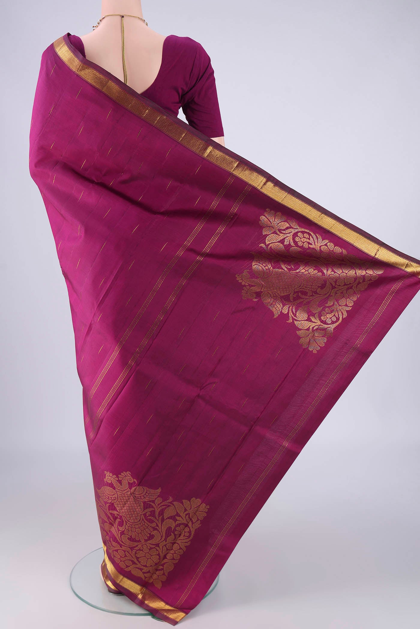 Flat view of Magenta Kanjivaram Silk Saree with Zari Butta on the body and Zari Border. 