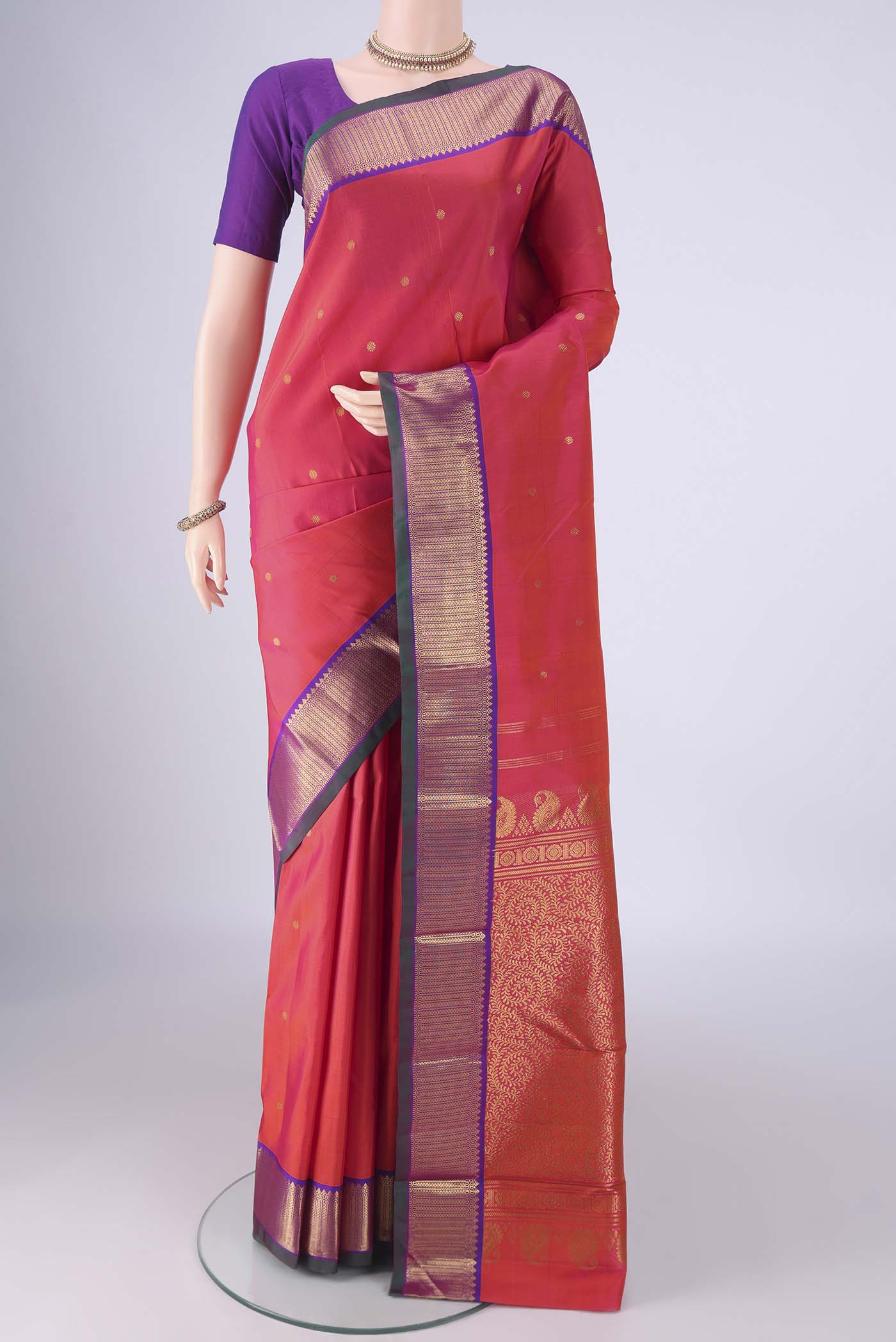 Pink Kanchipuram Silk Saree with Zari Butta on the body and Zari Border.  displayed on a mannequin
