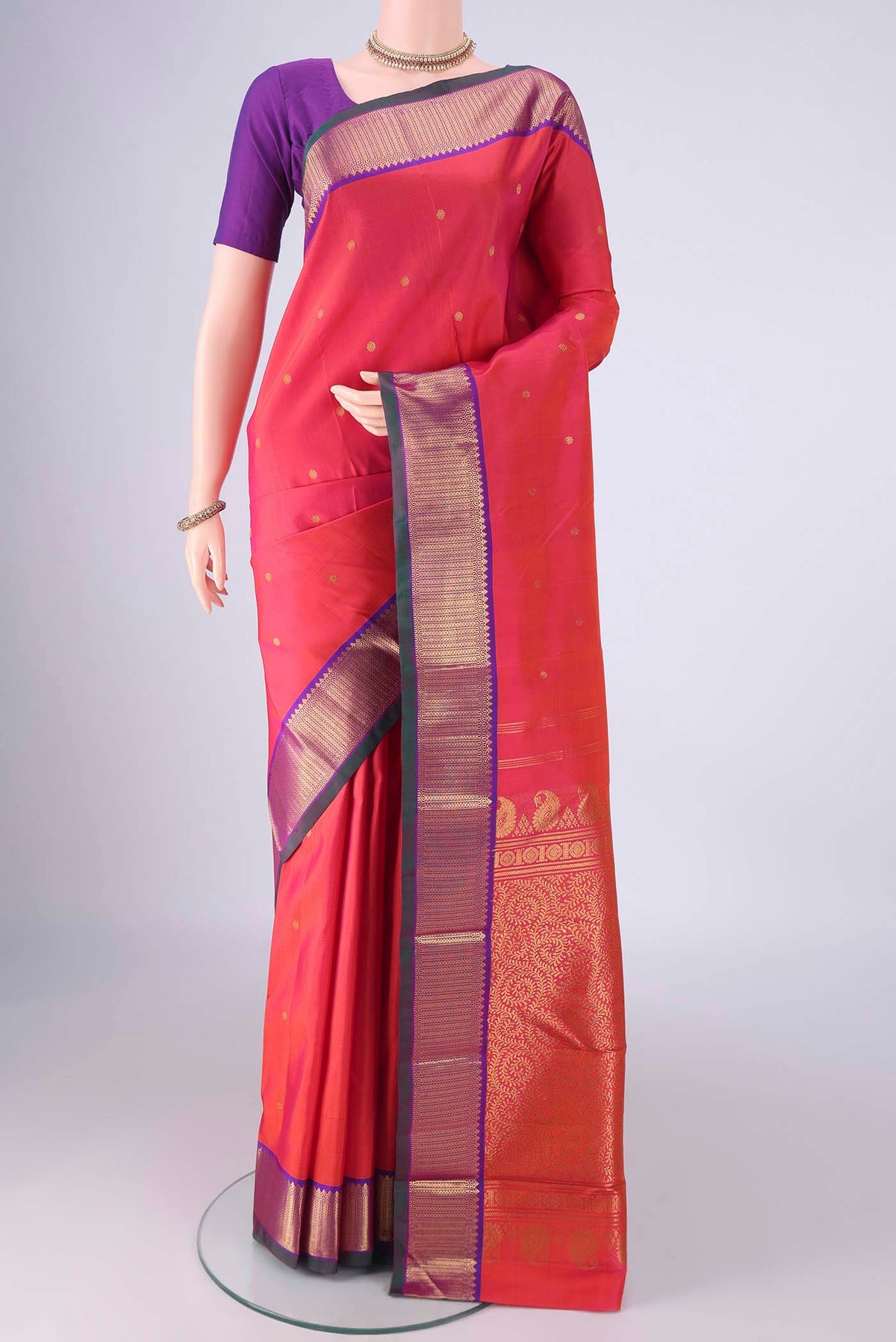 Pink Kanchipuram Silk Saree with Zari Butta on the body and Zari Border.  displayed on a mannequin
