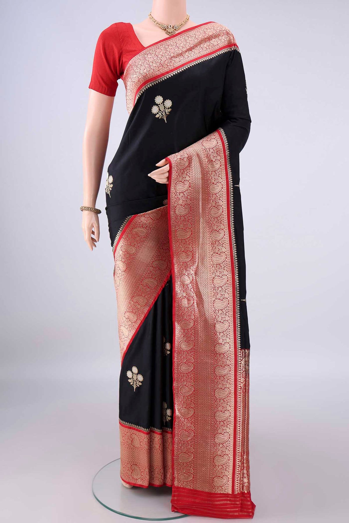 Pure Silk Black Banarasi Saree with Zari Butta on the body and Zari Border.  displayed on a mannequin