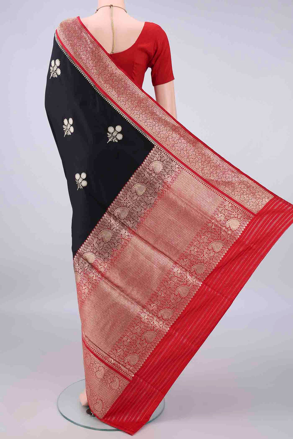 Flat view of Pure Silk Black Banarasi Saree with Zari Butta on the body and Zari Border. 