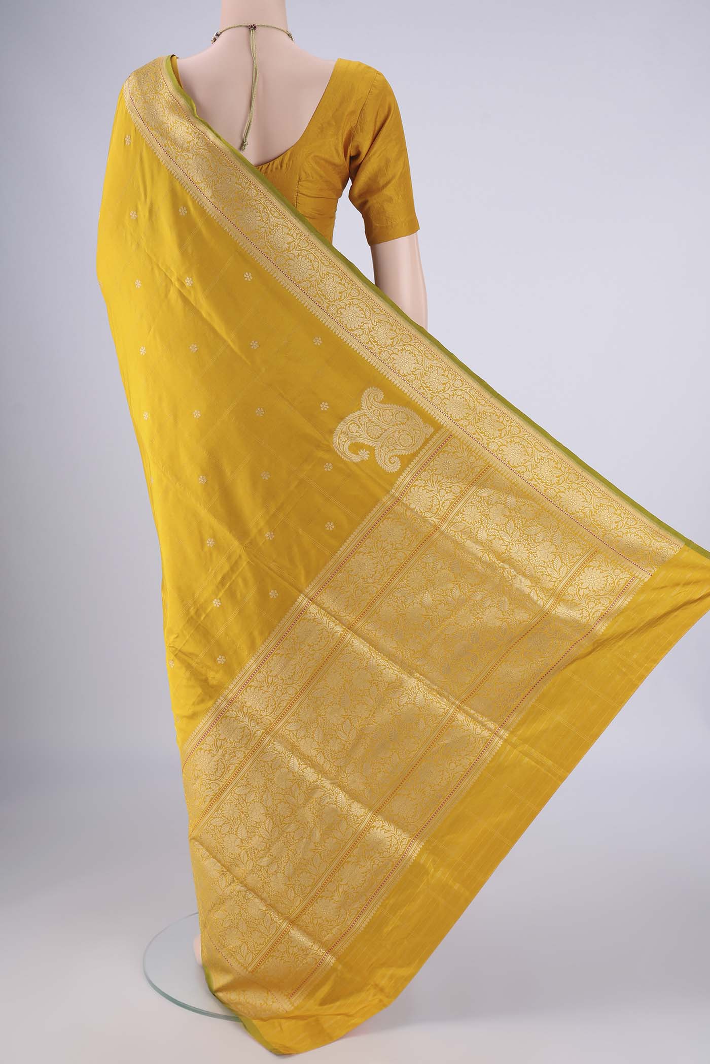 Flat view of Yellow Banarasi Silk Saree with Zari Butta on the body and Zari Border. 