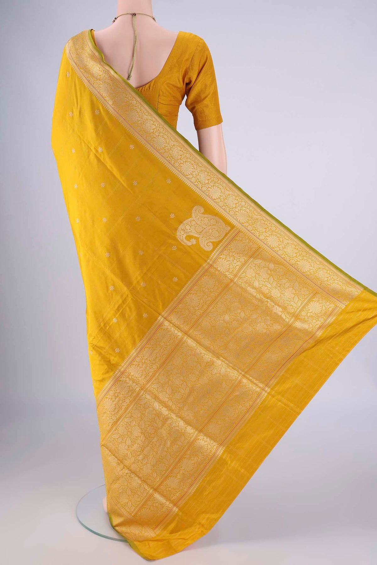 Flat view of Yellow Banarasi Silk Saree with Zari Butta on the body and Zari Border. 