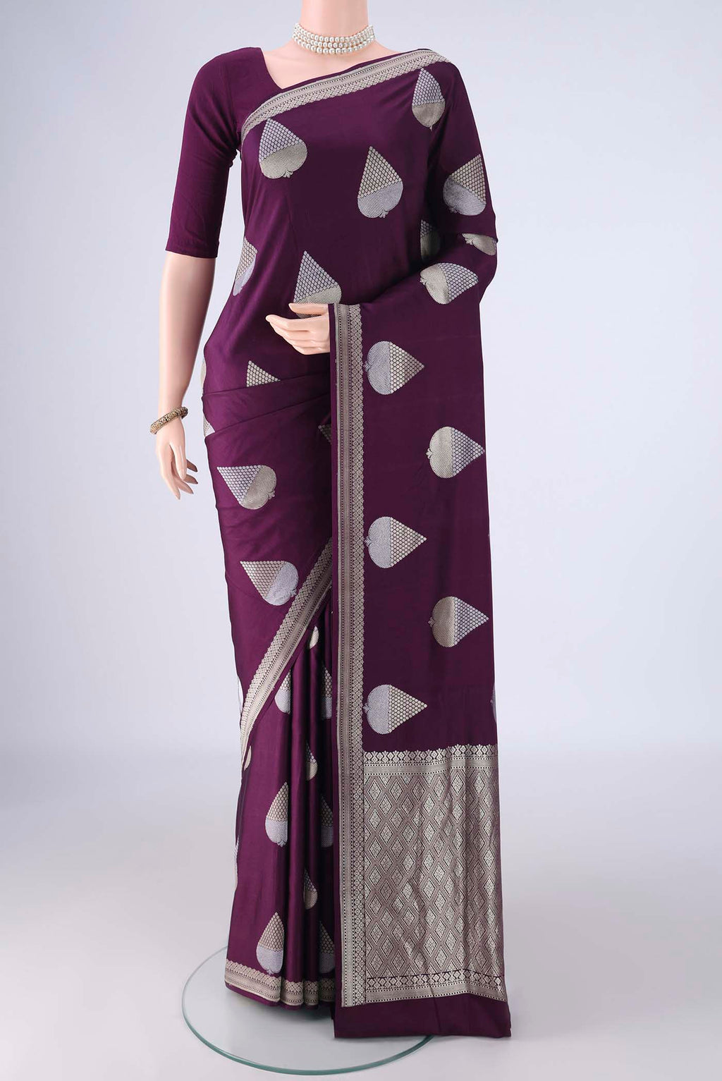 Burgundy Banarasi Silk Saree with Zari And Thread Butta on the body and Zari Border.  displayed on a mannequin
