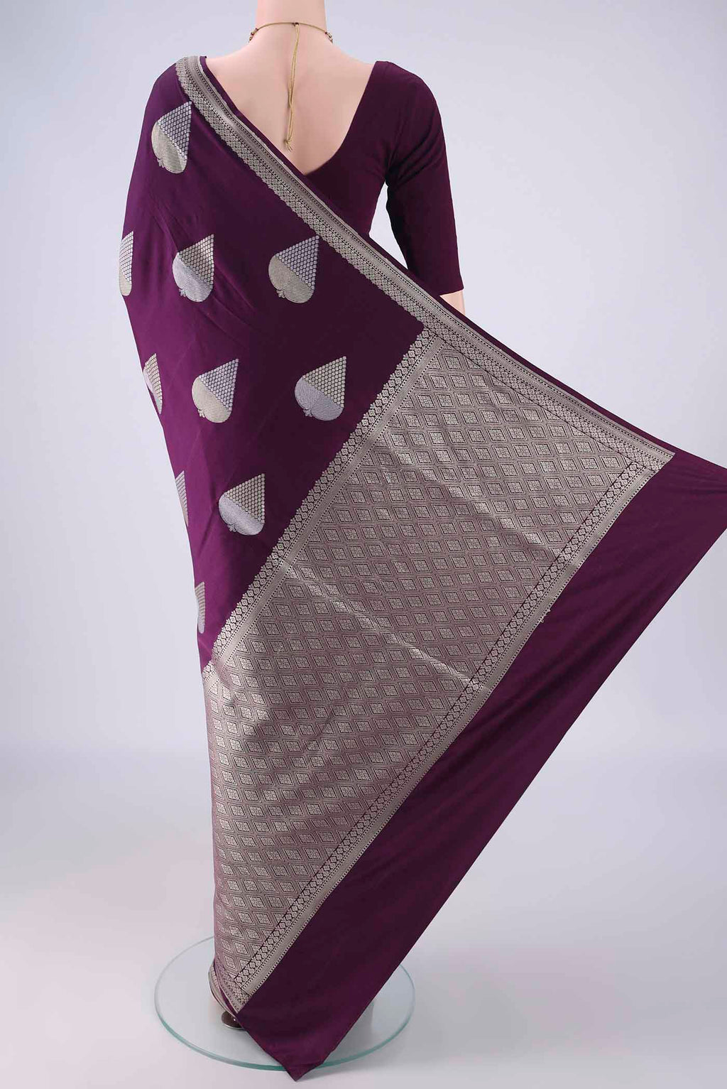 Flat view of Burgundy Banarasi Silk Saree with Zari And Thread Butta on the body and Zari Border. 