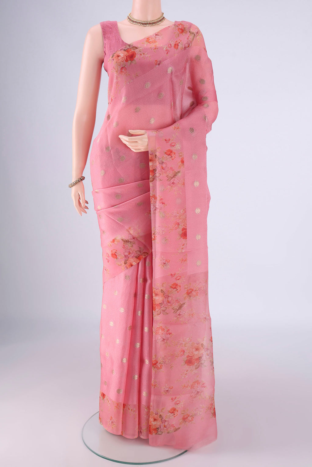 Rose pink Organza Silk Saree with Jacquard With Zari Butta on the body and Printed Border.  displayed on a mannequin