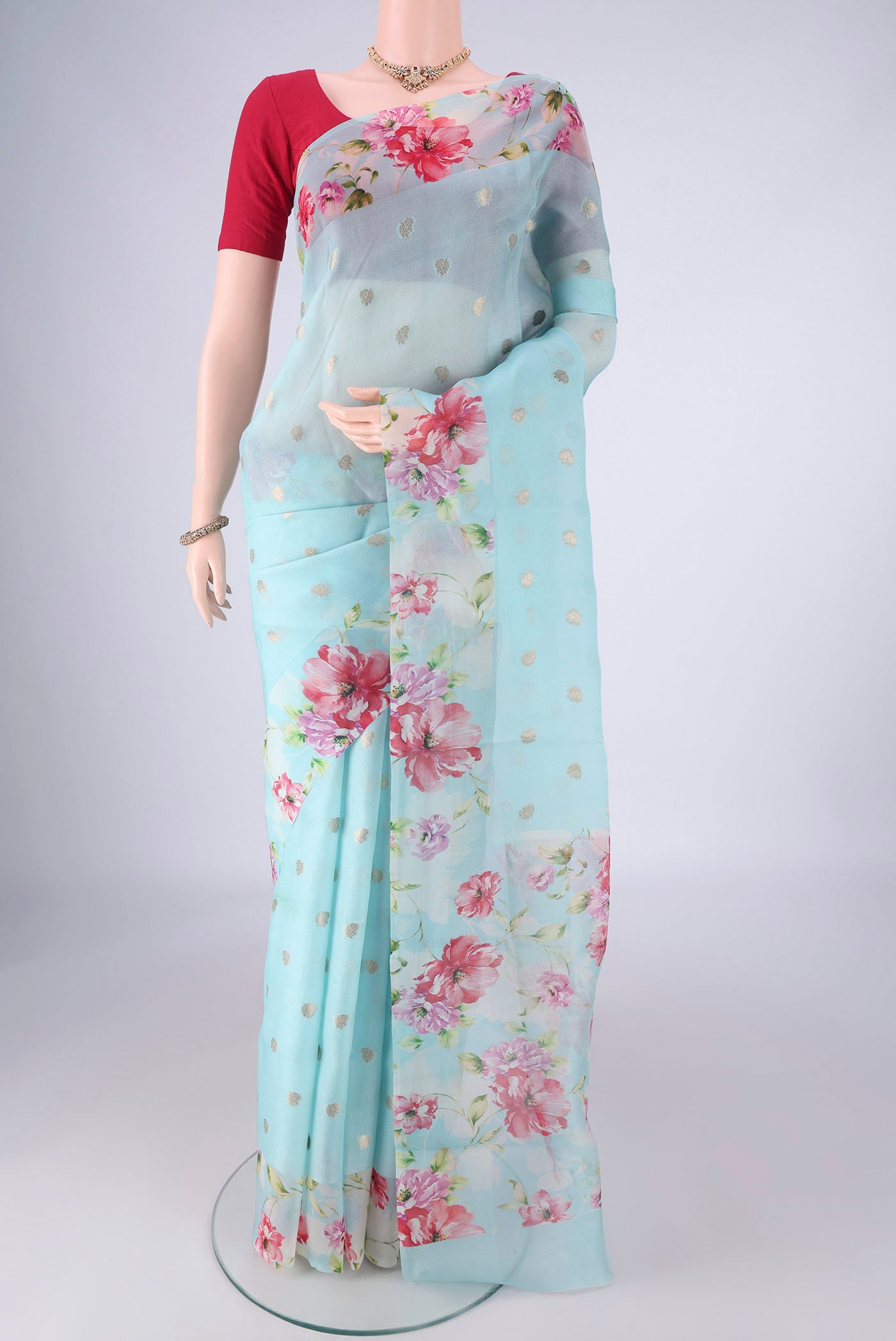 Light Blue Organza Silk Saree with Zari Butta on the body and Printed Border.  displayed on a mannequin