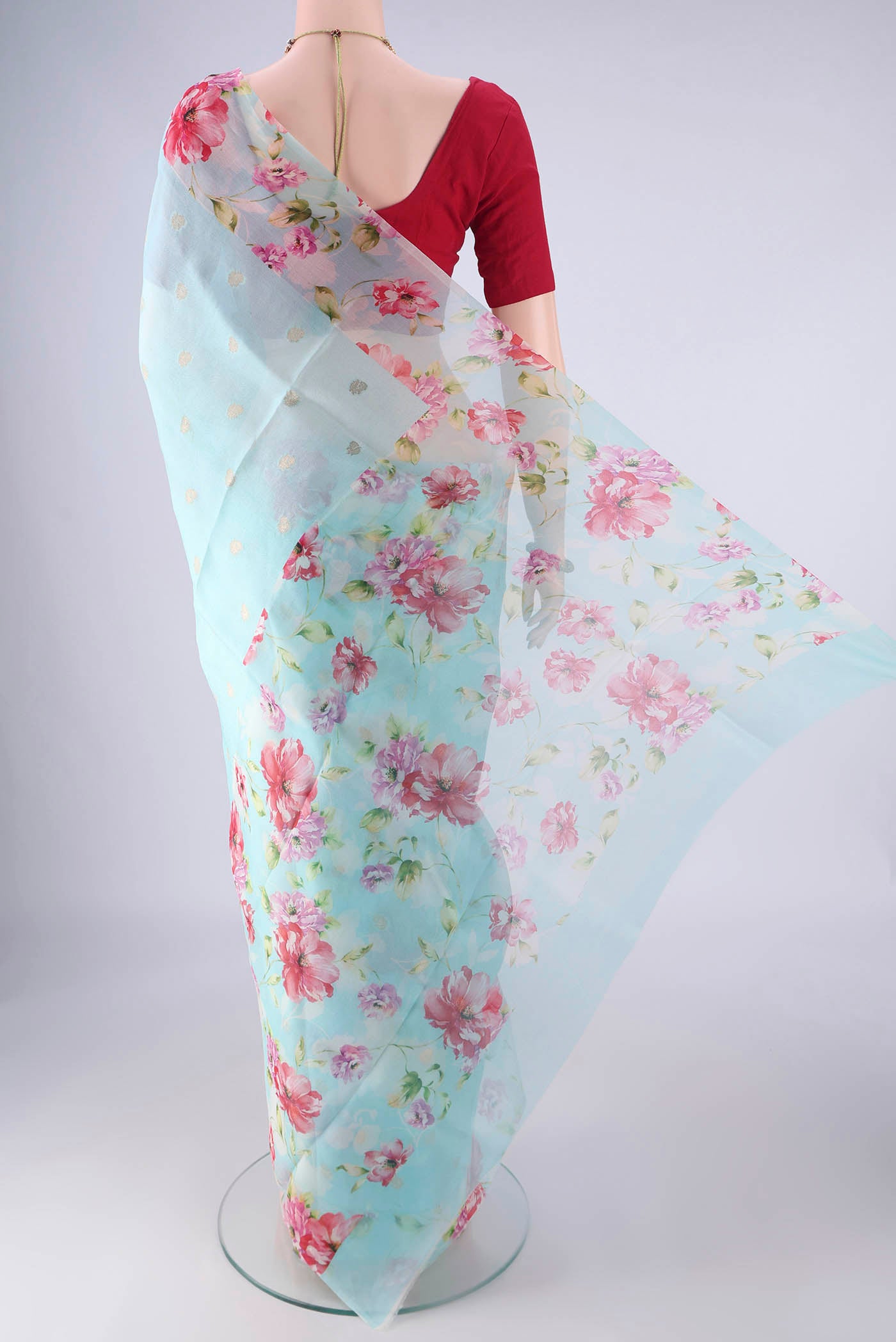 Flat view of Light Blue Organza Silk Saree with Zari Butta on the body and Printed Border. 