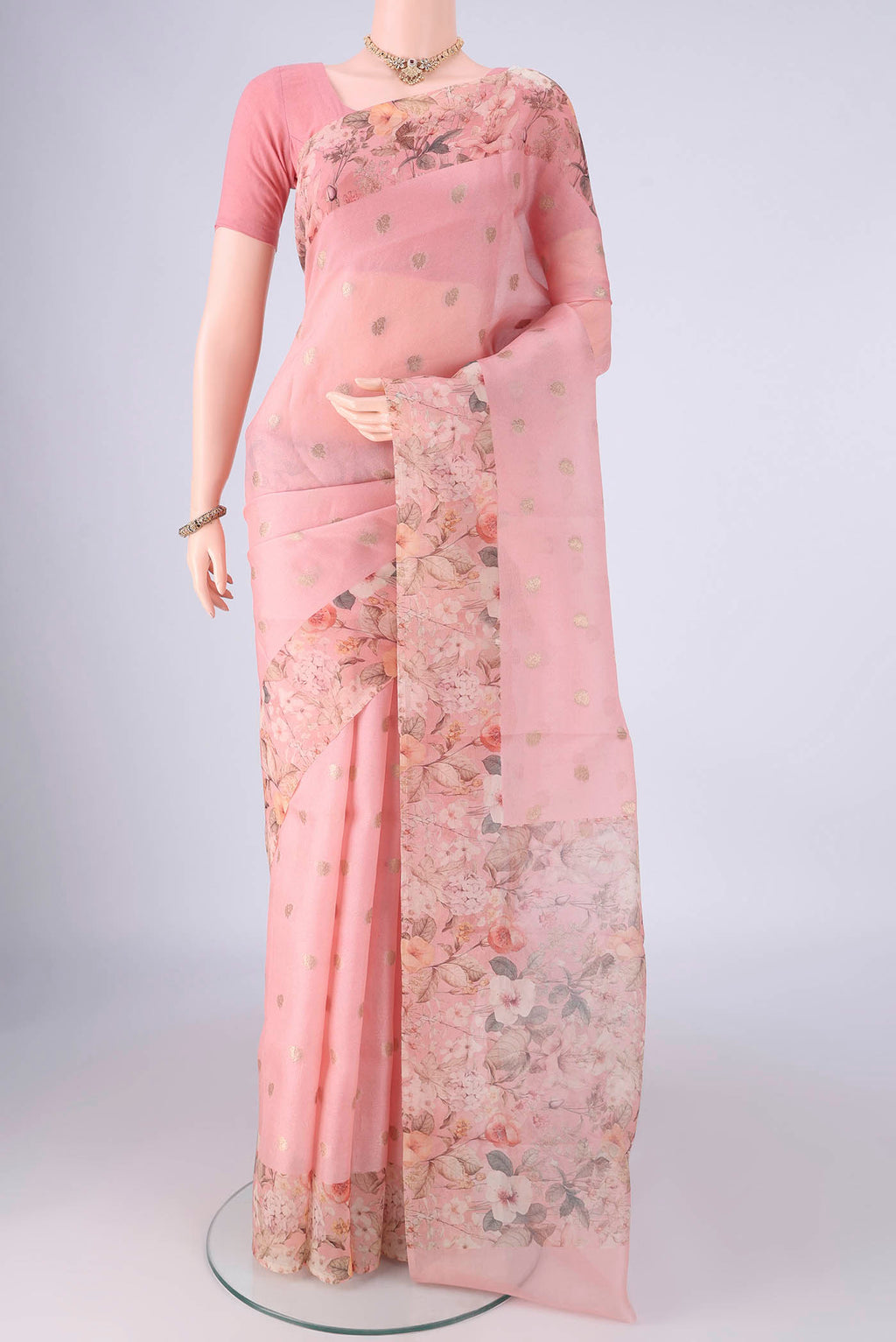 Rose pink Organza Silk Saree with Zari Butta on the body and Printed Border.  displayed on a mannequin