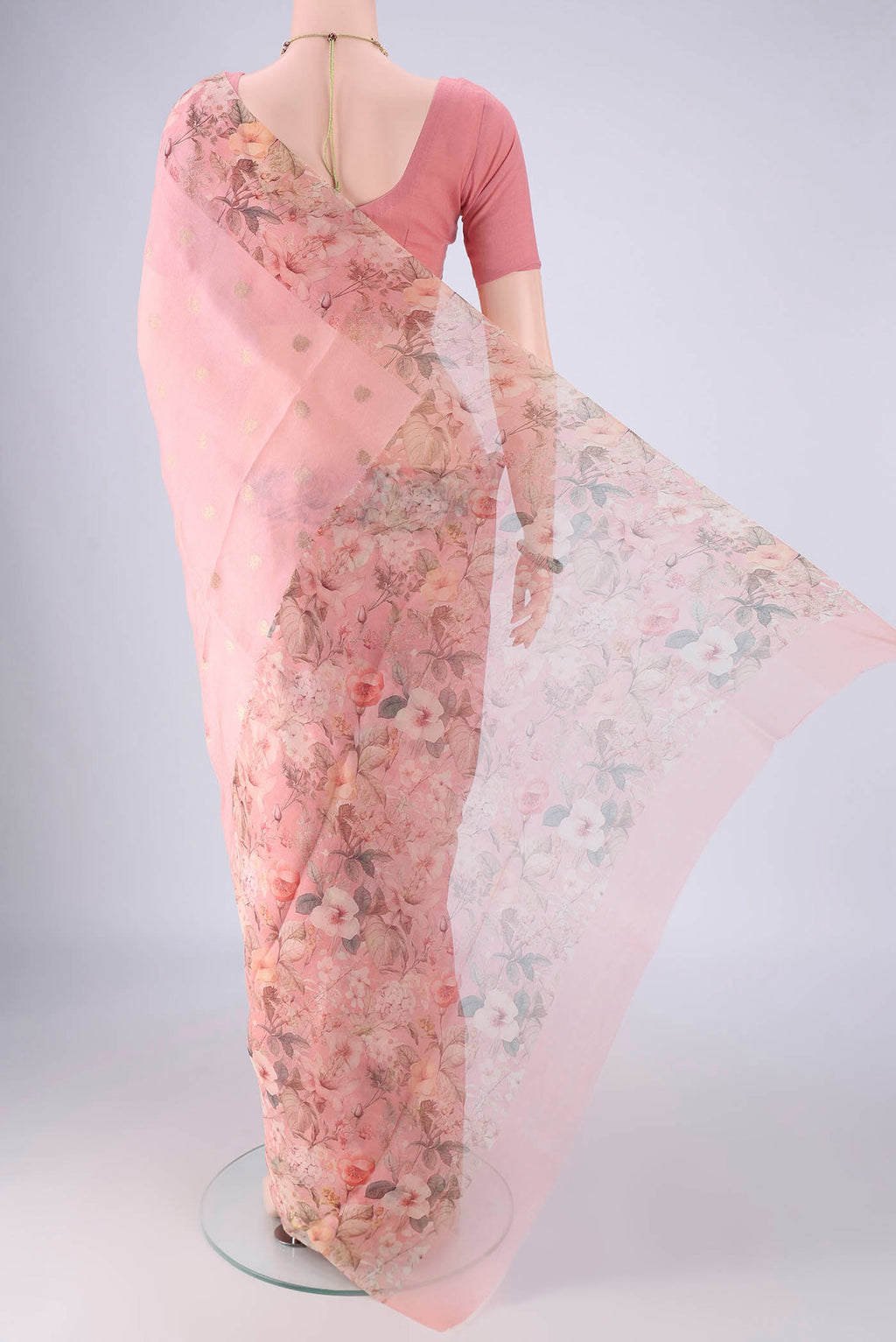 Flat view of Rose pink Organza Silk Saree with Zari Butta on the body and Printed Border. 