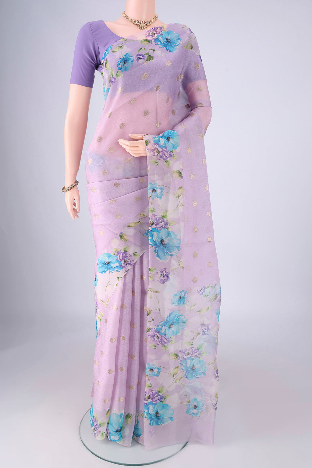Lavender Organza Silk Saree with Zari Butta on the body and Printed Border.  displayed on a mannequin