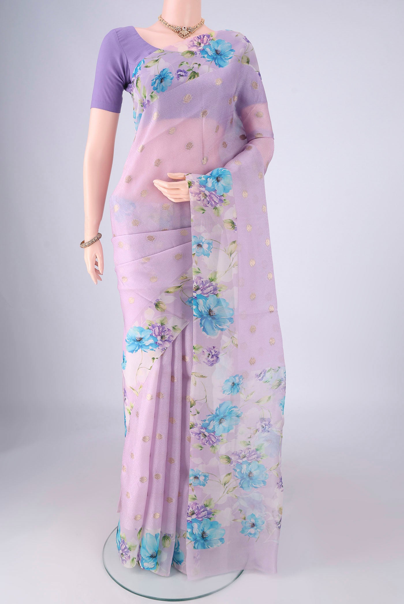 Lavender Organza Silk Saree with Zari Butta on the body and Printed Border.  displayed on a mannequin