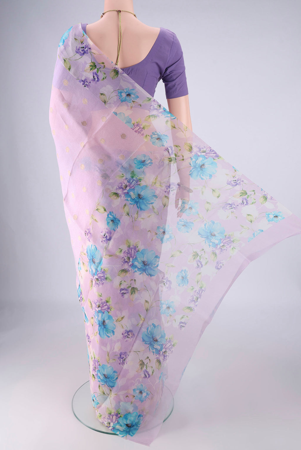 Flat view of Lavender Organza Silk Saree with Zari Butta on the body and Printed Border. 