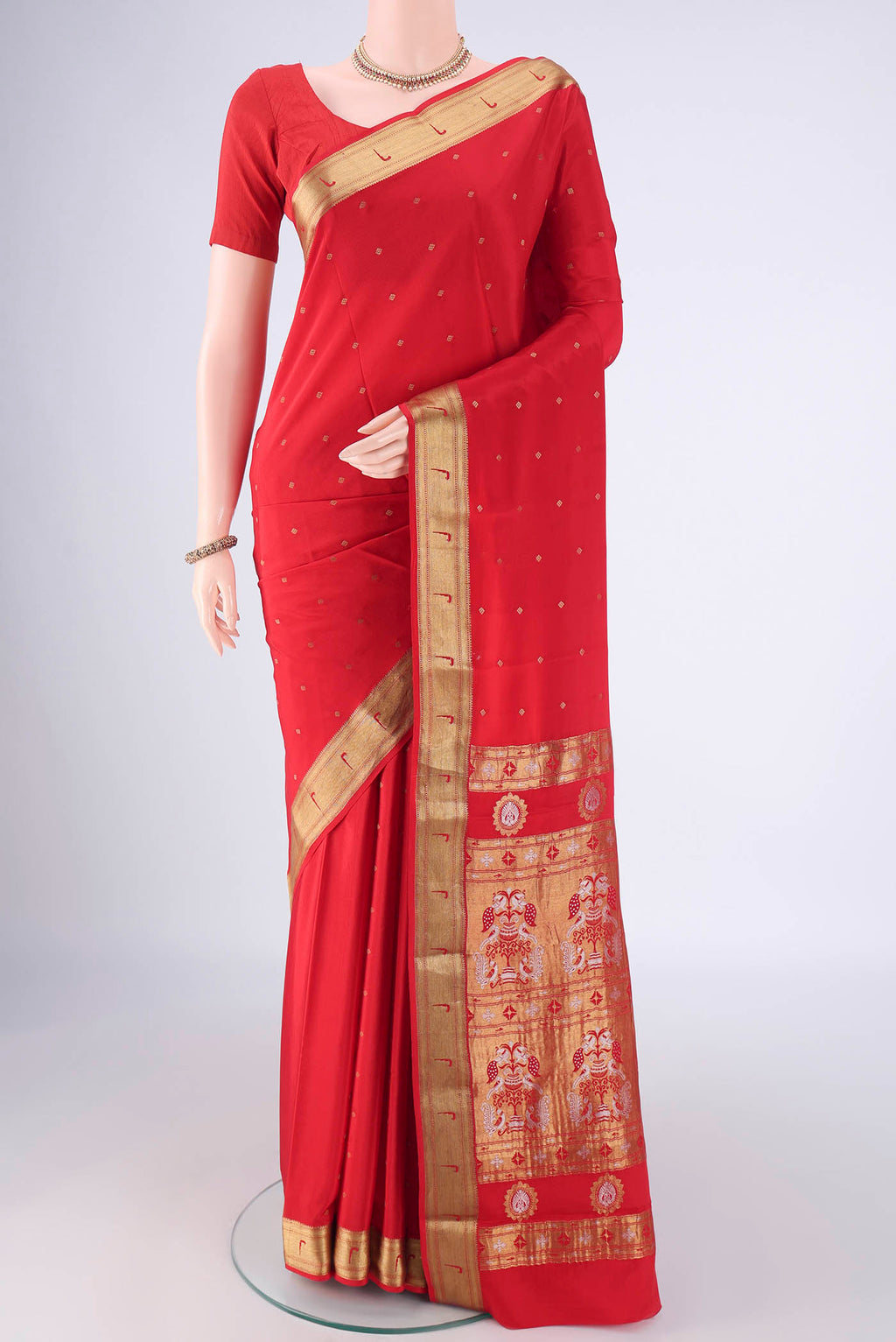 Red Mysore Crepe Saree with Zari Butta on the body and Zari Border.  displayed on a mannequin