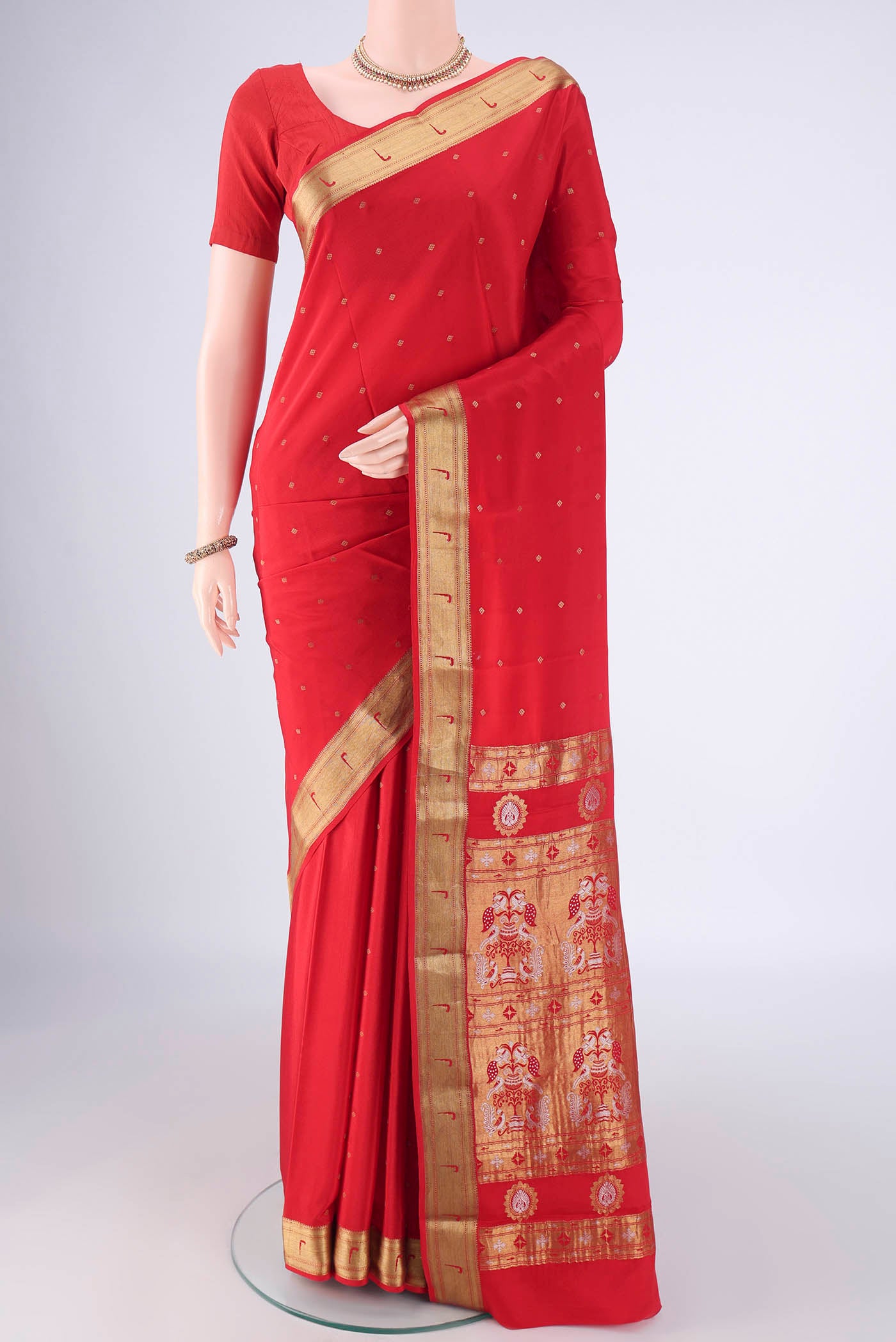 Red Mysore Crepe Saree with Zari Butta on the body and Zari Border.  displayed on a mannequin