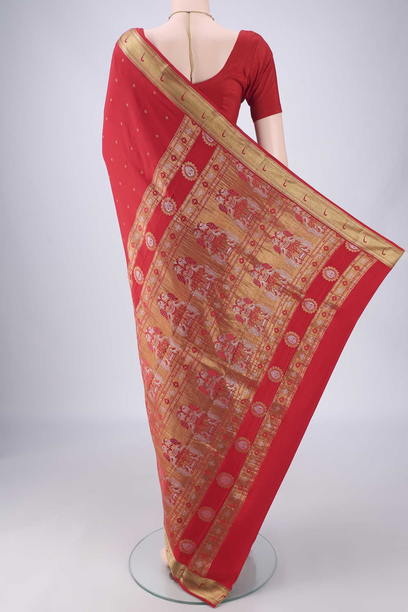 Flat view of Red Mysore Crepe Saree with Zari Butta on the body and Zari Border. 