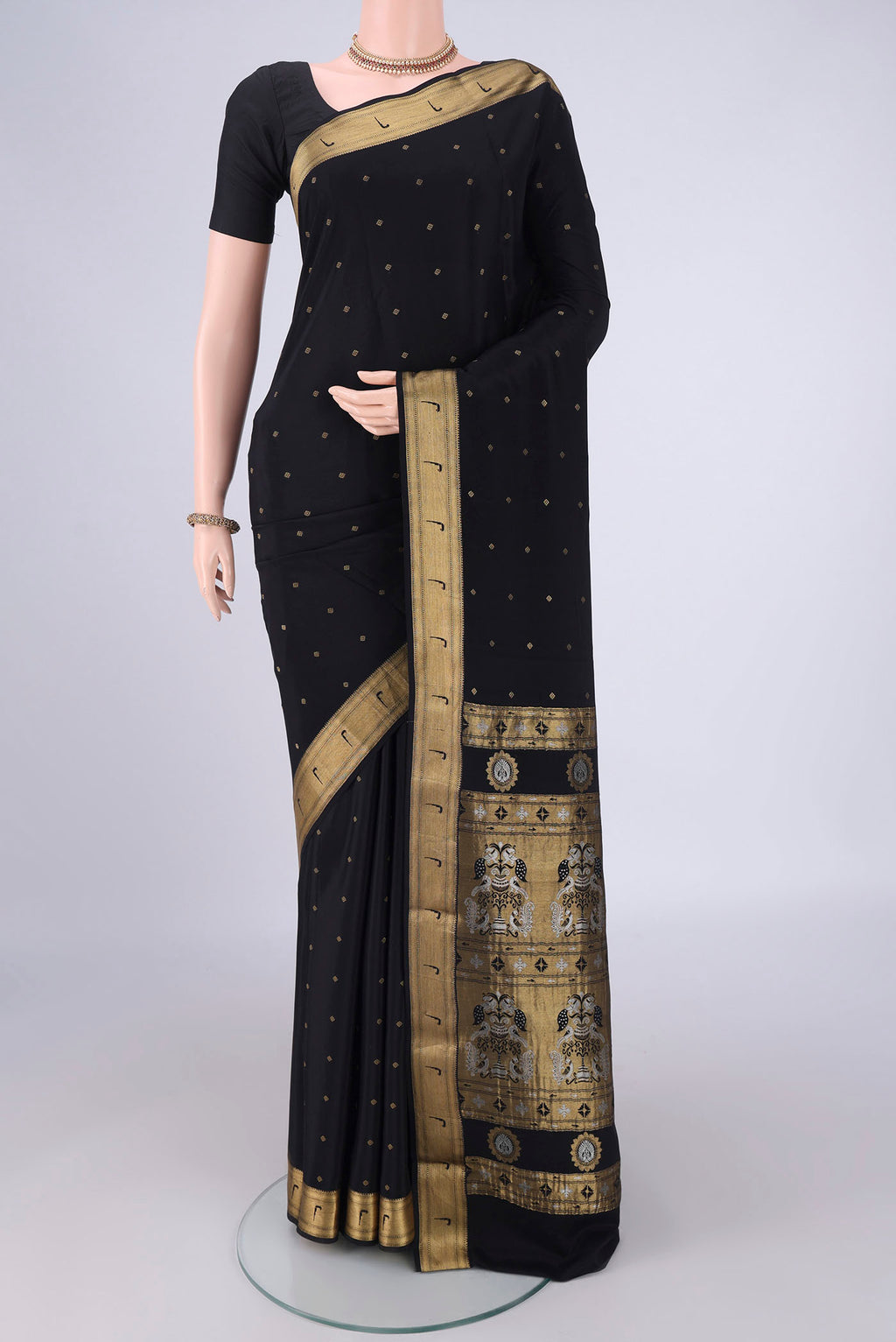 Black Mysore Crepe Saree with Zari Butta on the body and Zari Border.  displayed on a mannequin