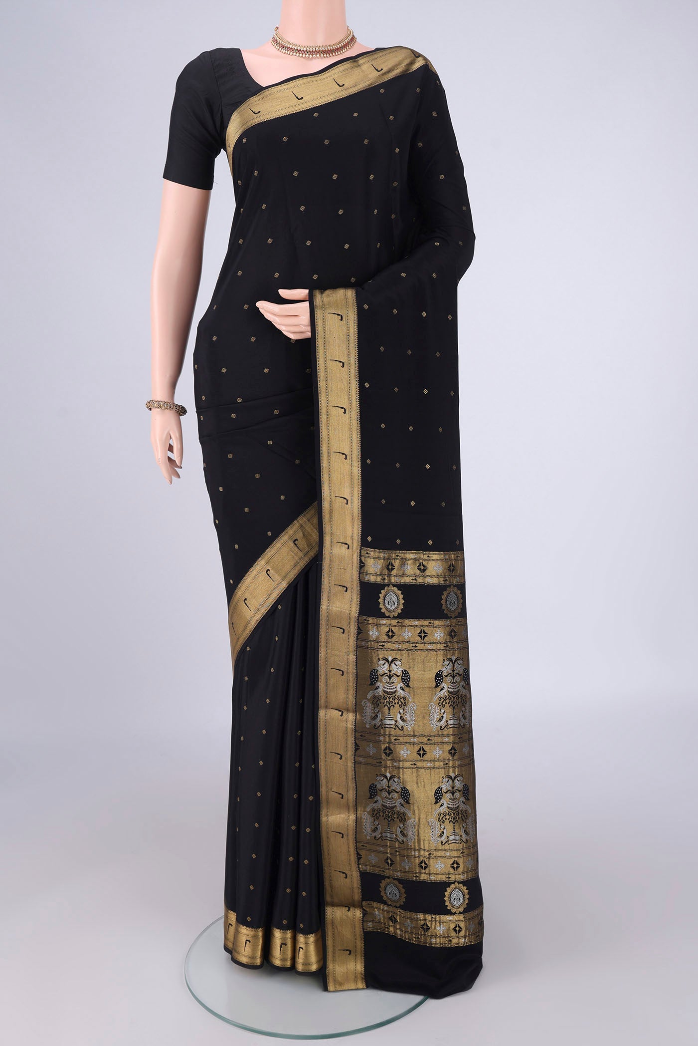 Black Mysore Crepe Saree with Zari Butta on the body and Zari Border.  displayed on a mannequin