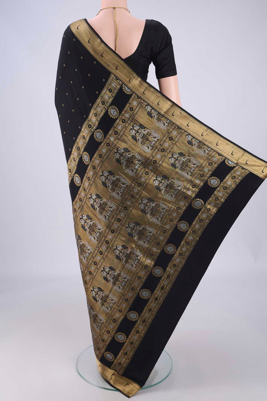 Flat view of Black Mysore Crepe Saree with Zari Butta on the body and Zari Border. 