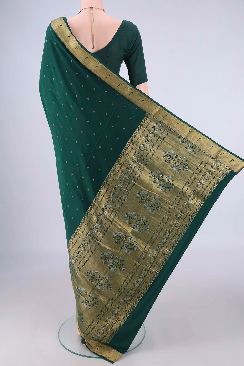 Flat view of Bottle Green Mysore Crepe Saree with Zari Butta on the body and Zari Border. 