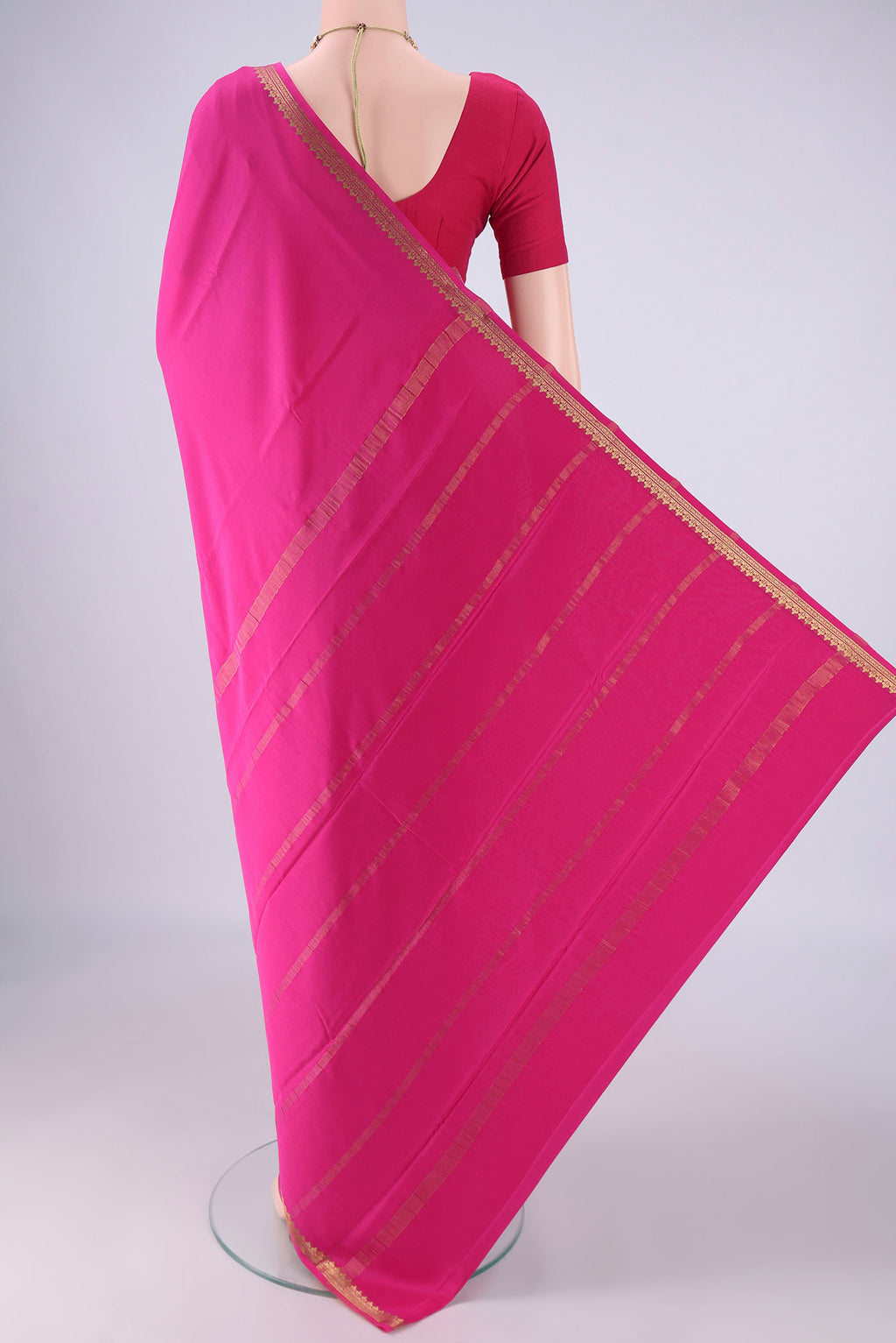 Flat view of Rani Pink Mysore Crepe Saree with Plain Body and Zari Border. 