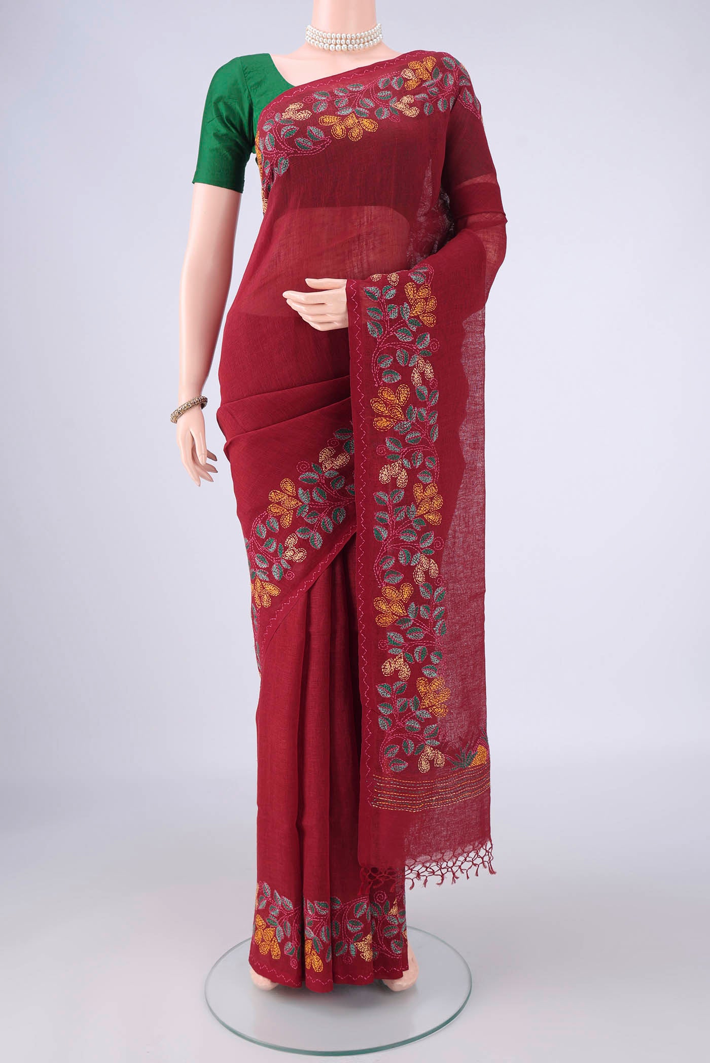Maroon Linen Saree with Kantha Work on the body and Embroidery Border.  displayed on a mannequin