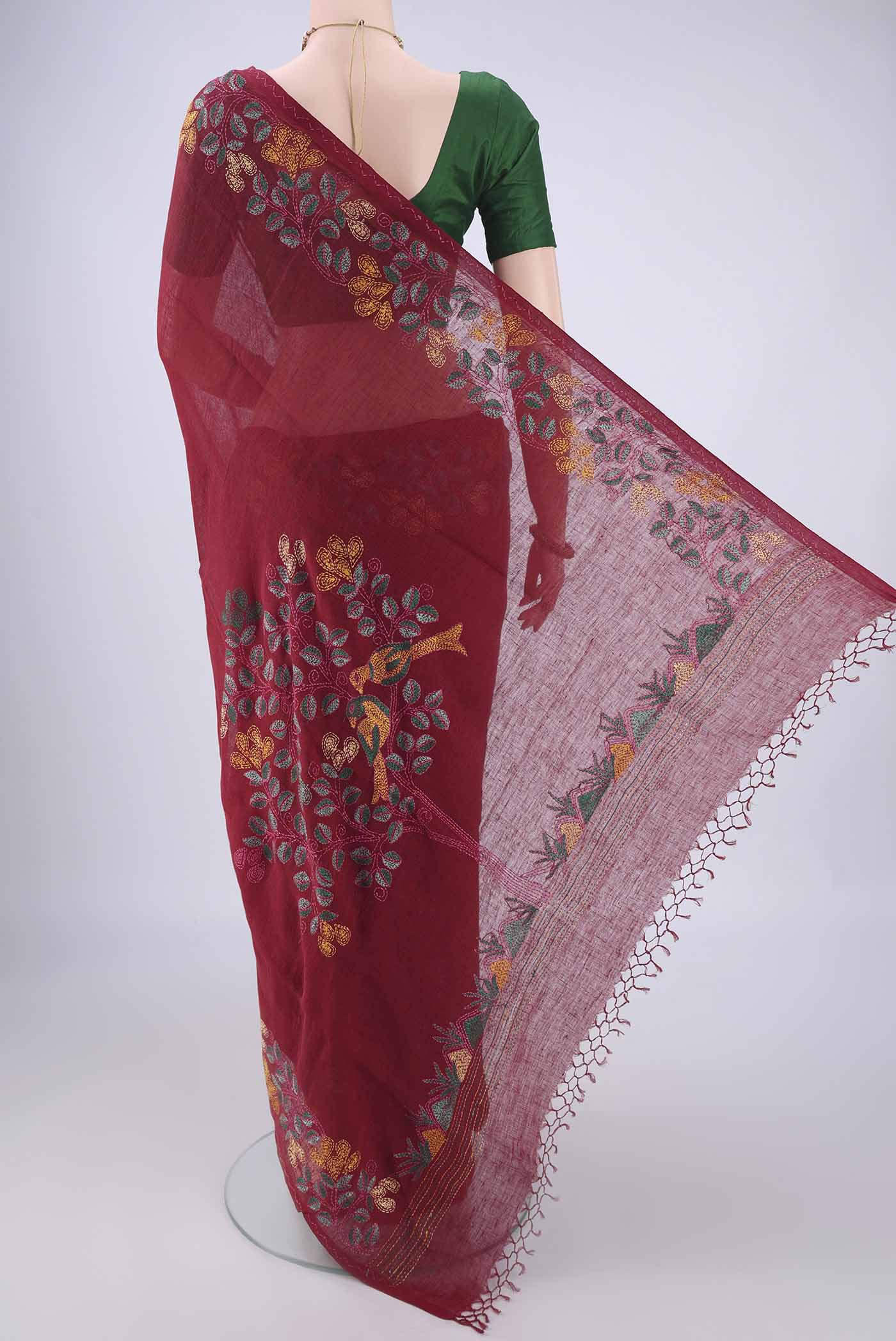 Flat view of Maroon Linen Saree with Kantha Work on the body and Embroidery Border. 