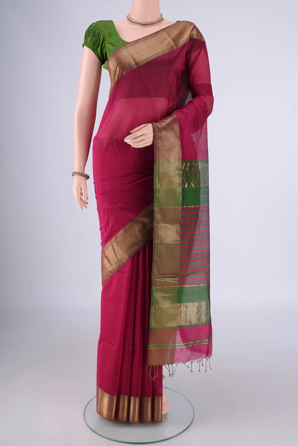 Magenta Maheshwari Silk Cotton Saree with Plain Body and Zari Border.  displayed on a mannequin