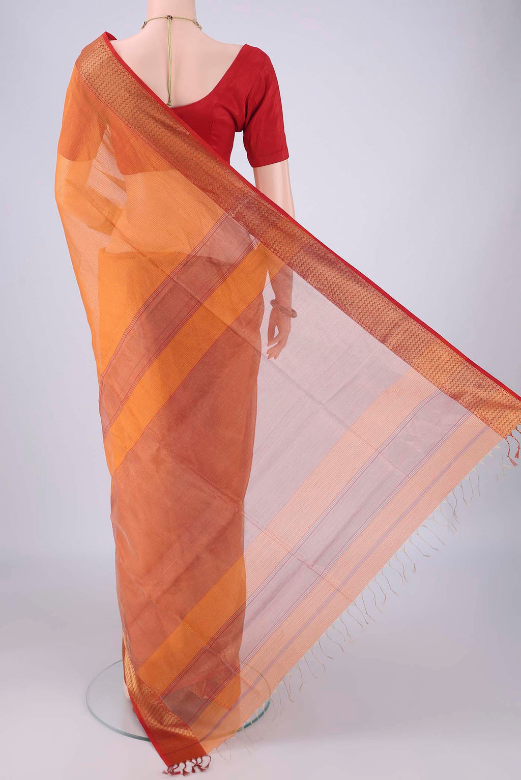 Flat view of Orange Maheshwari Silk Cotton Saree with Checked design on the body and Zari Border. 