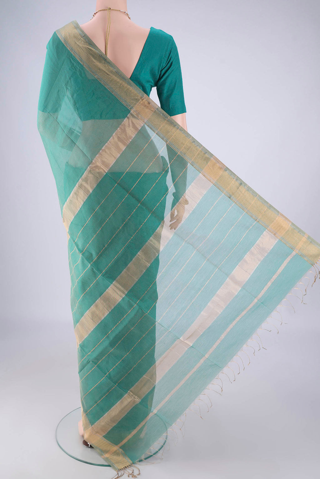 Flat view of Sea Green Maheshwari Silk Cotton Saree with Stripes on the body and Zari Border. 